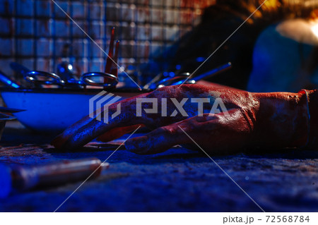 A creepy room with bloodstained walls and medical instruments. A creepy room with bloodstained walls and medical instruments. 72568784