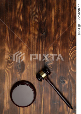 Judge hammer on brown wooden background with copy of space Judge hammer on brown wooden background with copy of space 72569077