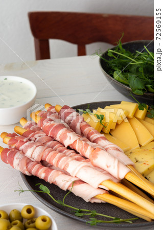 Bread sticks with bacon and cheese 72569155