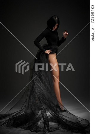 sexy brunette woman in long black dress sexy brunette woman in long black dress 72569438