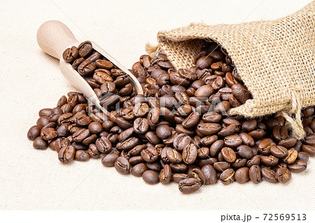 Bag with fresh roasted coffee beans isolated on on white cloth. Bag with fresh roasted coffee beans isolated on on white cloth. 72569513