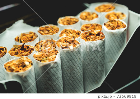 A pack of white cigarettes photographed close-up 72569919