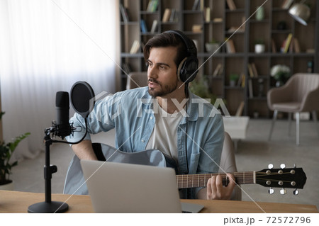 Male artist play record song on guitar Male artist play record song on guitar 72572796