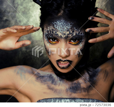 fashion portrait of pretty young woman with creative make up like a snake, halloween concept fashion portrait of pretty young woman with creative make up like a snake, halloween concept 72573036
