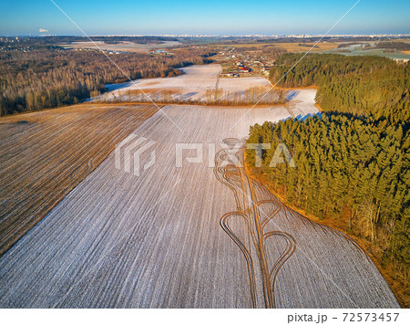 Winter Agricultural field under snow. Aerial scene. December Rural landscape. Winter Agricultural field under snow. Aerial scene. December Rural landscape. 72573457