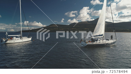 Closeup of motor boat sails at yachts on ocean bay aerial. Sunlight over seascape, water transport 72578494