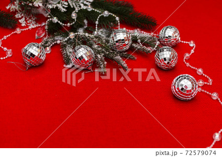 christmas layout with new year balls and fir sprigs on a red fabric background with a place for an inscription christmas layout with new year balls and fir sprigs on a red fabric background with a place for an inscription 72579074