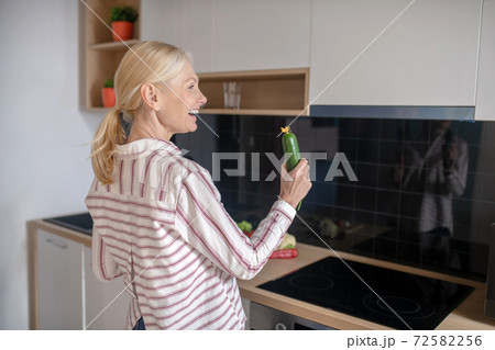 Blonde housewife having fun in the kitchen and feeling joyful 72582256