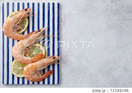 Cooked tiger prawns on striped plate Cooked tiger prawns on striped plate 72589286