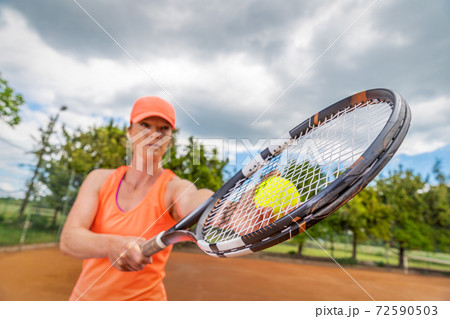 close up shot of a tennis racket in a players hand 72590503