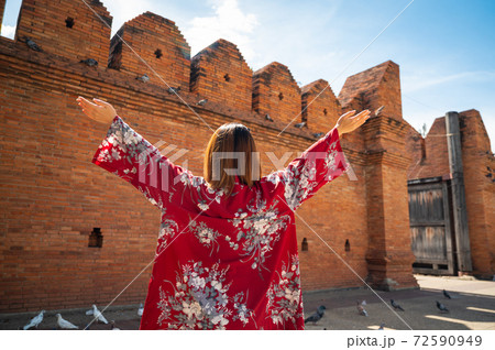 Asian woman traveling at Tha Phae Chiangmai old city wall in northern Thailand 72590949