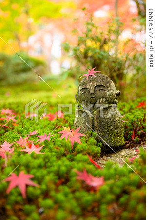 Red Maple leaf on head of Jizo sculpture doll Red Maple leaf on head of Jizo sculpture doll 72590991