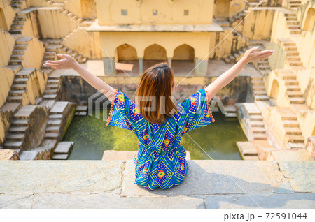 Portrait of young woman traveling in India step-well at Jaipur in Rajasthan state, India 72591044