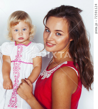 young pretty stylish mother with little cute blond daughter hugging, happy smiling real family, lifestyle people concept 72591124