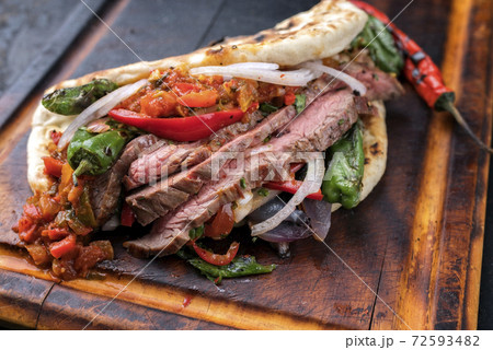 barbecue dry aged wagyu flank steak with chili relish and vegetable in a flatbread barbecue dry aged wagyu flank steak with chili relish and vegetable in a flatbread 72593482