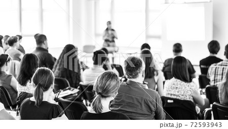 Speaker giving a talk in conference hall at business meeting event. Rear view of unrecognizable people in audience at the conference hall. Speaker giving a talk in conference hall at business meeting event. Rear view of unrecognizable people in audience at the conference hall. 72593943