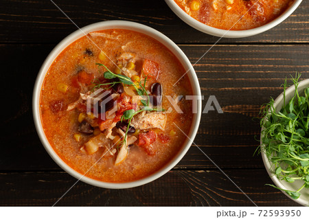 Soup with beans and corn, tomatoes and chicken breast 72593950