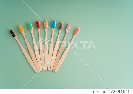 A set of Eco-friendly antibacterial toothbrushes made of bamboo wood on a light green background. Environmental care trends A set of Eco-friendly antibacterial toothbrushes made of bamboo wood on a light green background. Environmental care trends 72594671