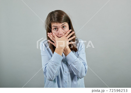Covering mouth with palm. Can't say anything. Shocked gasping amazed stunning 72596253