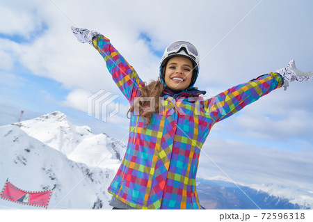 Woman on a terrace admiring in the snowy mountains Woman on a terrace admiring in the snowy mountains 72596318