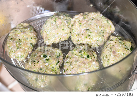 above view of chicken cutlets in electric steamer above view of chicken cutlets in electric steamer 72597192