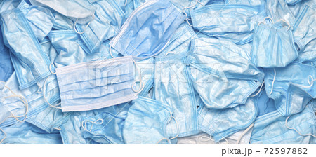 Used mask background. Disposal Coronavirus. Trash mask. Covid-19 waste. Rubbish. Discarded. Medical waste. Disposal. Waste. Litter mask. Contaminated. Garbage out. Covid-19 background. Masks in bin. 72597882
