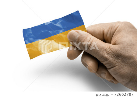 Hand holding a card with a national flag the Ukraine Hand holding a card with a national flag the Ukraine 72602787