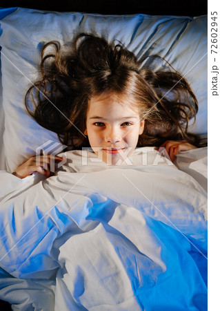 top view. pretty girl is lying in bed. healthy sleep. comfortable orthopedic bed 72602945