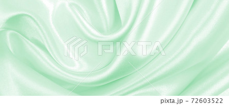 Smooth elegant green silk or satin luxury cloth texture as abstract background. Luxurious background design 72603522