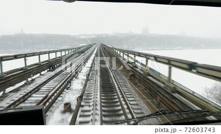 Train moves on the bridge across the river. 72603743