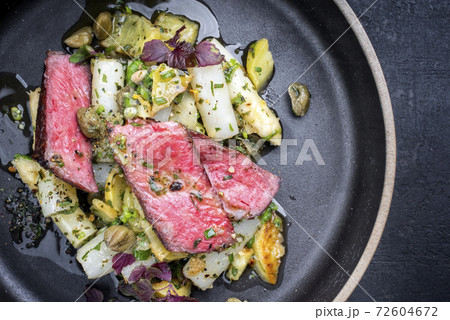 dry aged sliced filet steak with asparagus potato salad 72604672