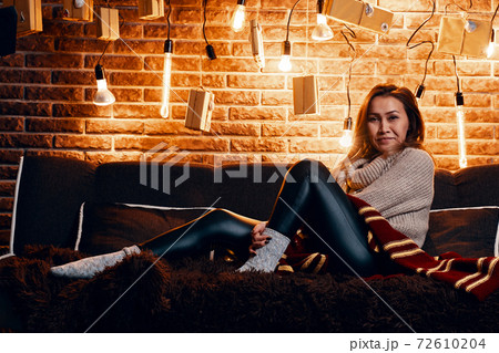 Cute girl sitting on the couch. 72610204