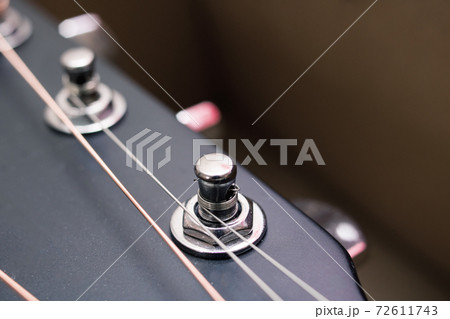 Black and yellow guitar strings closeup macro photography 72611743