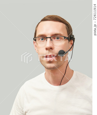 Men in call center. White t-shirt. Headset for telemarketing Men in call center. White t-shirt. Headset for telemarketing 72611914