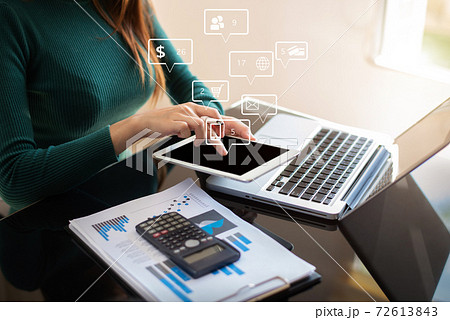 Businesswomen working with laptop and digital tablet computer in office with digital marketing media in virtual icon. Businesswomen working with laptop and digital tablet computer in office with digital marketing media in virtual icon. 72613843
