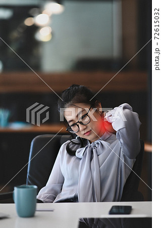 Stressed business woman suffering from shoulder and neck pain after work hard in office. Stressed business woman suffering from shoulder and neck pain after work hard in office. 72615032