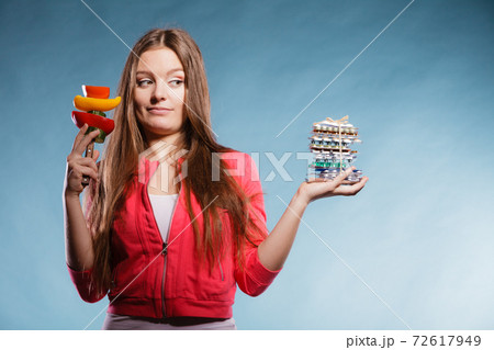 Woman holding pills and vegetables. Health care Woman holding pills and vegetables. Health care 72617949