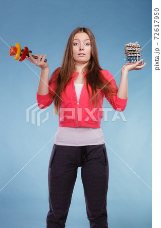 Woman with diet weight loss pills and vegetables. Woman with diet weight loss pills and vegetables. 72617950