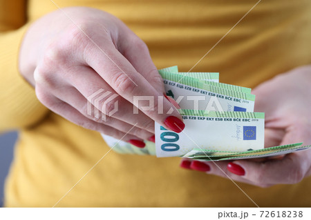 Woman holding lot of euro cash in her hands closeup Woman holding lot of euro cash in her hands closeup 72618238
