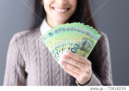 Woman holding euro cash in her hands closeup Woman holding euro cash in her hands closeup 72618239
