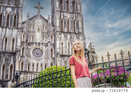 Young woman tourist on background of St Joseph's Cathedral in Hanoi. Vietnam reopens after coronavirus quarantine COVID 19 Young woman tourist on background of St Joseph's Cathedral in Hanoi. Vietnam reopens after coronavirus quarantine COVID 19 72619779