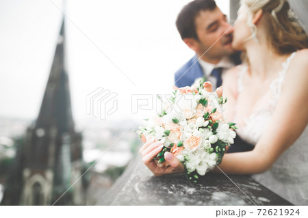 Perfect couple bride, groom posing and kissing in their wedding day Perfect couple bride, groom posing and kissing in their wedding day 72621924