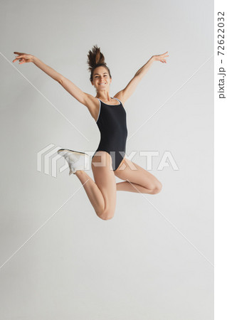 Beautiful young woman's portrait isolated on grey studio background. Having fun, happy, full length 72622032