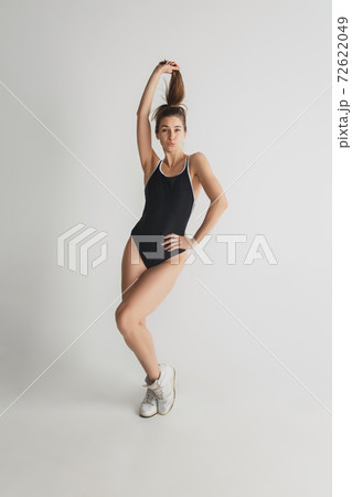 Beautiful young woman's portrait isolated on grey studio background. Having fun, happy, full length Beautiful young woman's portrait isolated on grey studio background. Having fun, happy, full length 72622049