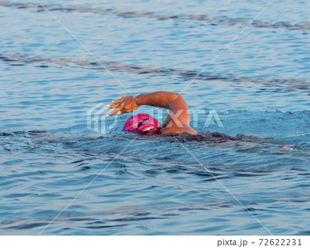 Female swimming freestyle in a pool alone 72622231