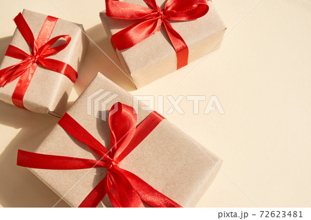 Presents with red ribbon on the bright background .,, 72623481