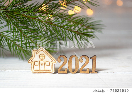 New Year composition with the numbers 2021 and a small house on 72625619