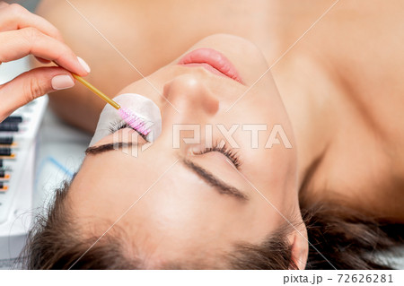 Stylist making lengthening lashes. Stylist making lengthening lashes. 72626281