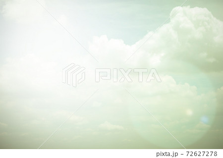 Sky with soft fluffy clouds in vintage color tone with sun flare Sky with soft fluffy clouds in vintage color tone with sun flare 72627278