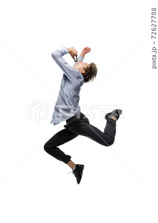 Happy young man dancing in casual clothes or suit, remaking legendary moves of celebrity from culture history 72627708
